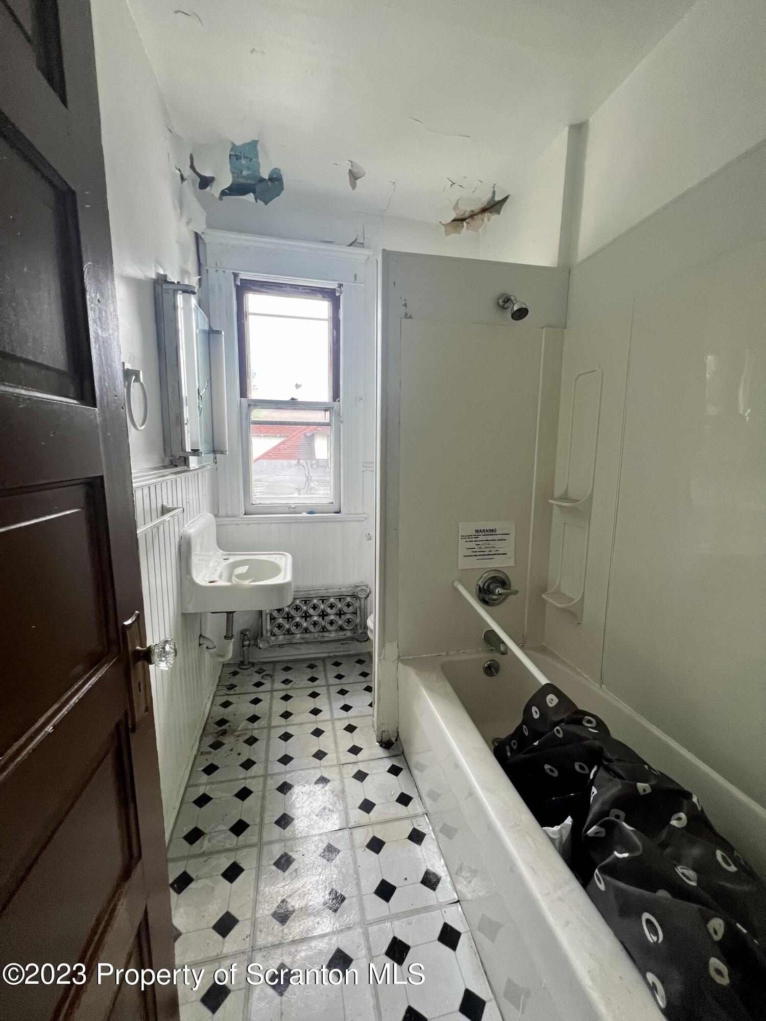 352-354 Maple Street Scranton, PA 18505 - Photo 18 of 22 a bathroom with a black and white checkered floor