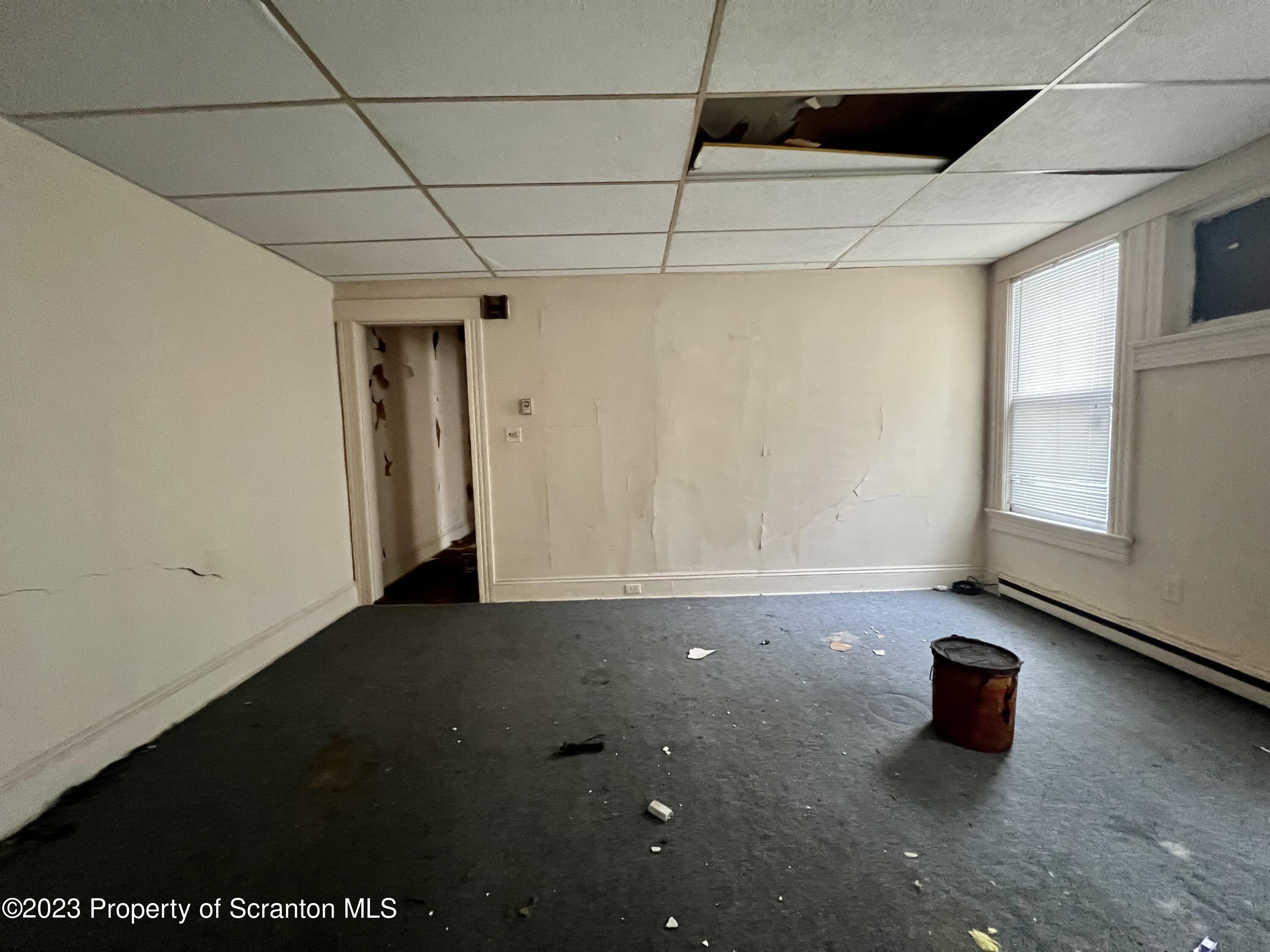 352-354 Maple Street Scranton, PA 18505 - Photo 22 of 22 a room with water heater and a wooden floor