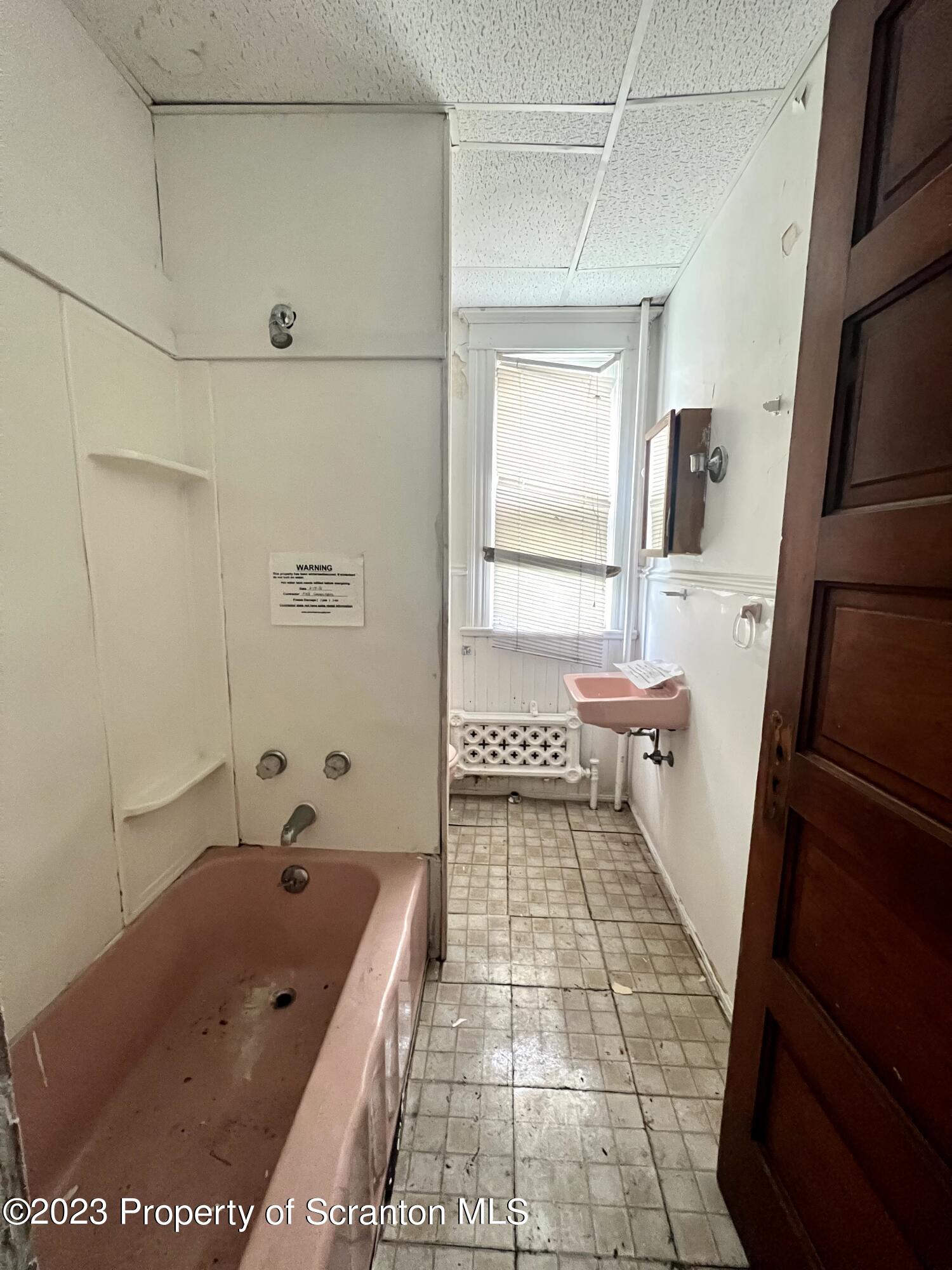 352-354 Maple Street Scranton, PA 18505 - Photo 3 of 22 a bathroom with a sink a toilet and shower