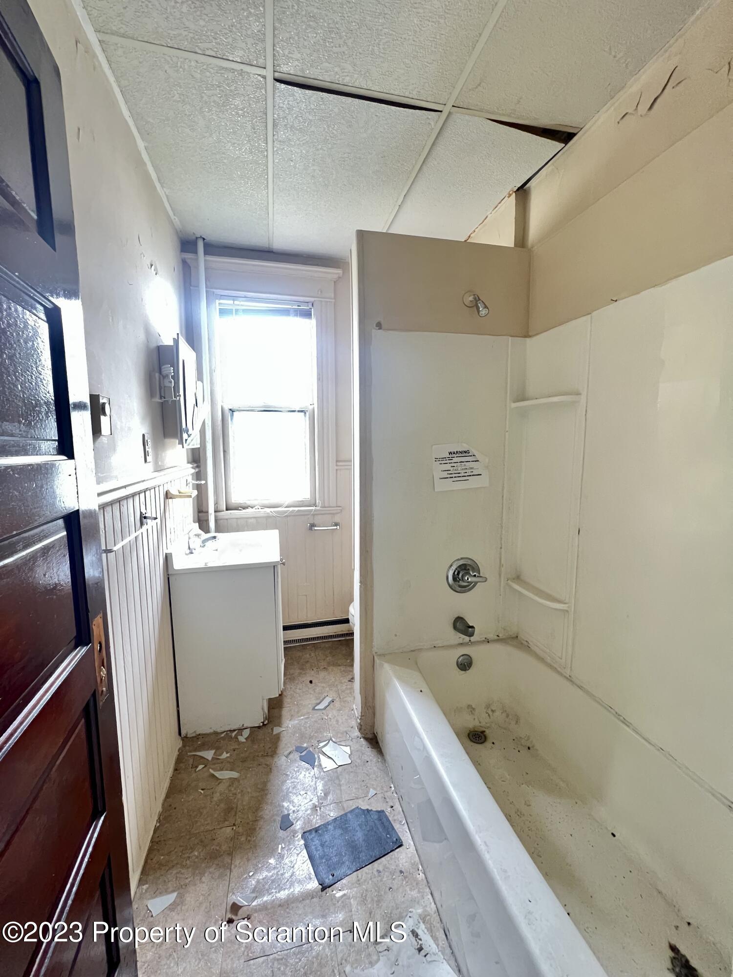352-354 Maple Street Scranton, PA 18505 - Photo 9 of 22 a bathroom with a bathtub a sink a toilet and a shower