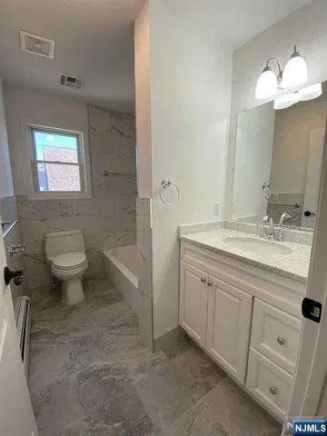 a bathroom with a sink a toilet and a mirror
