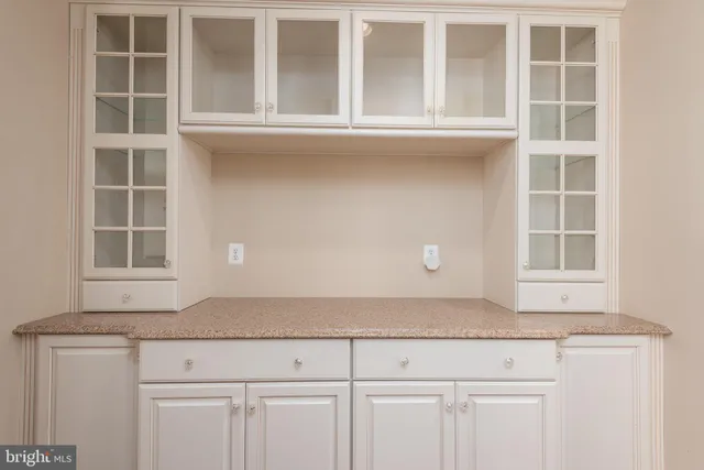 a kitchen with granite countertop cabinets and window