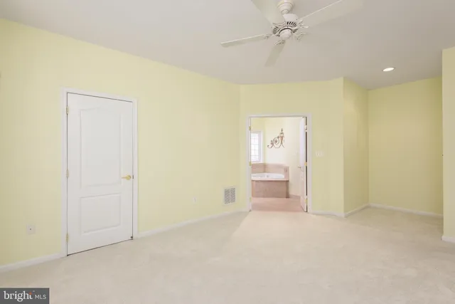 an empty room with a cabinet and a shower