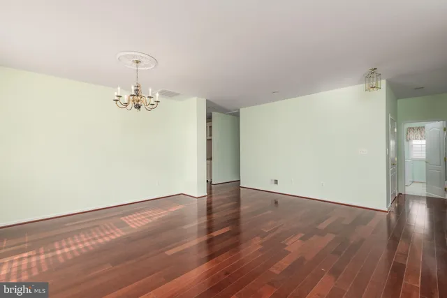 a view of a room with wooden floor and sink