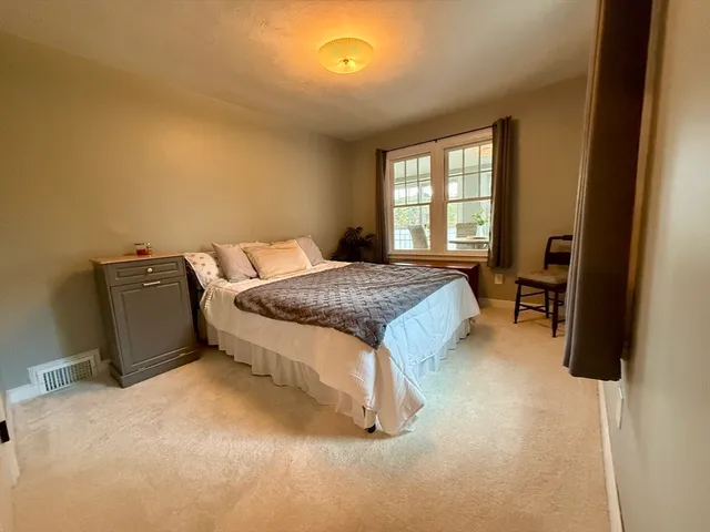 a spacious bedroom with a bed and a window