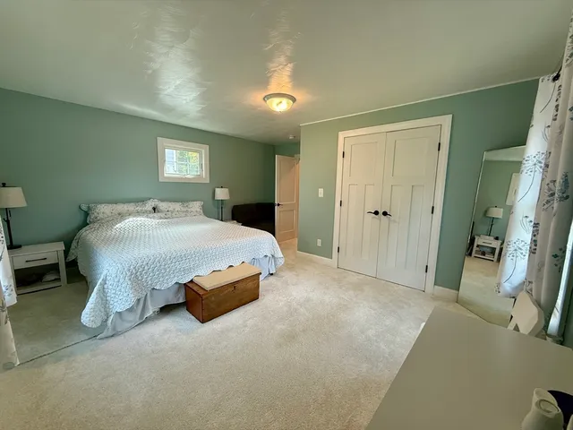 a bedroom with a bed and a night stand