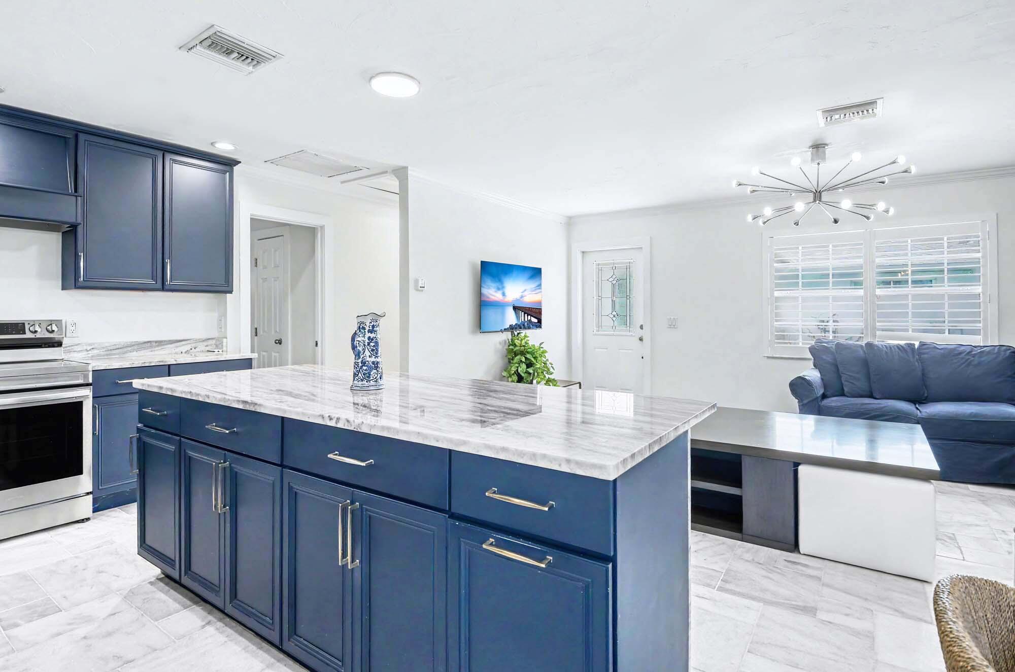 112 Capri Boulevard Naples, FL 34113 - Photo 8 of 29 a kitchen with center island a sink stainless steel appliances and cabinets