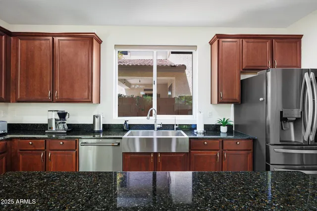 a view of a hallway with wooden floor and a bathroom