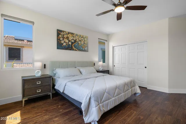 a bedroom with a bed and a ceiling fan