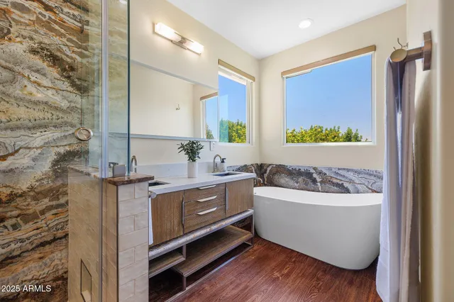 a bathroom with a bathtub sink and mirror