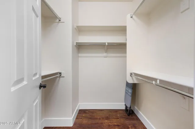 a view of walk in closet with empty racks