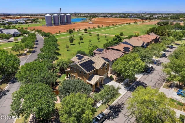 an aerial view of a house with garden space and street view