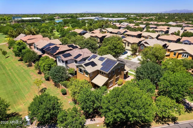 an aerial view of residential houses with outdoor space and street view