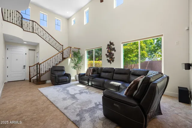 a bedroom with a bed window and a flat screen tv