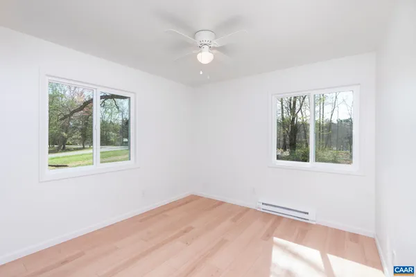 an empty room with a stove and a window