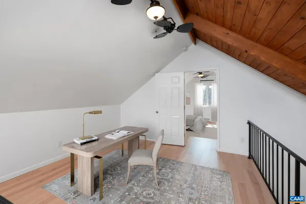 a view of a room with wooden floor and white walls