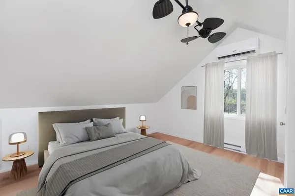 an empty room with wooden floor cabinet and windows