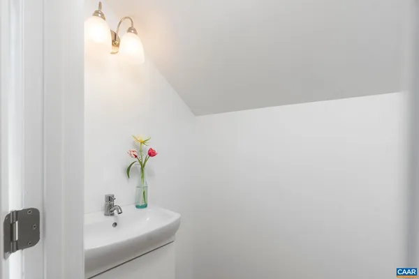 a living room with furniture a fireplace and a potted plant
