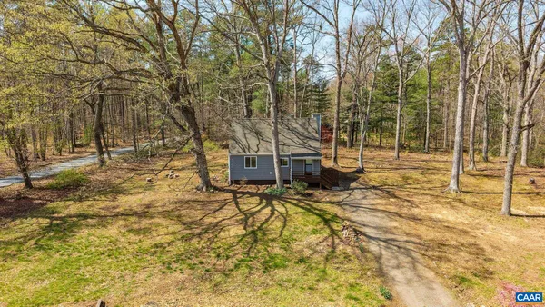 a view of house with backyard