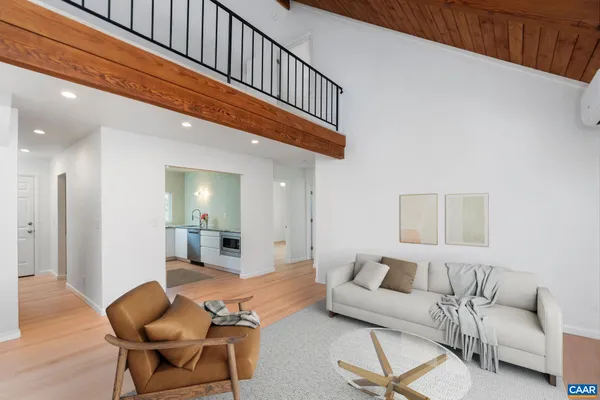 a living room with furniture and a dining table