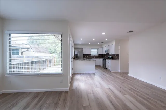 a white house that has a tree in front of it