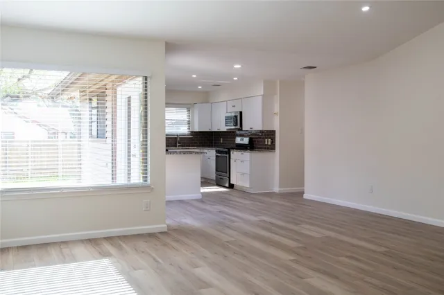 a view of a kitchen with a stove cabinets and wooden floor