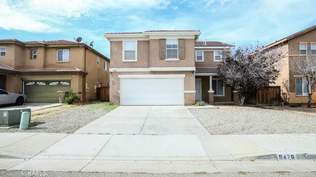 a front view of a house with a yard and a garage