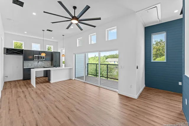 a view of kitchen with refrigerator and wooden floor