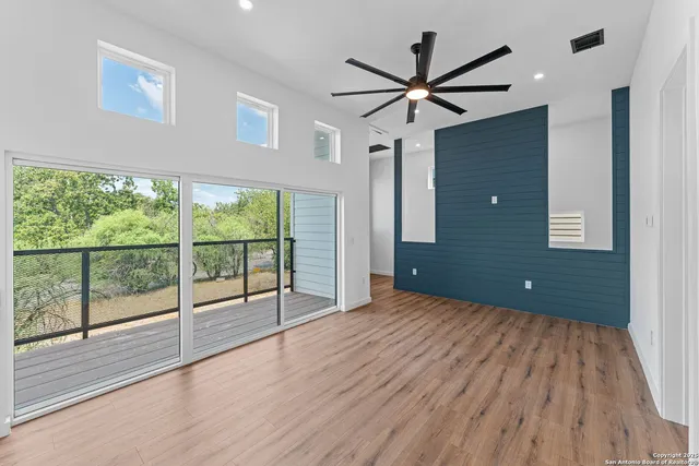a view of a livingroom with a ceiling fan and window