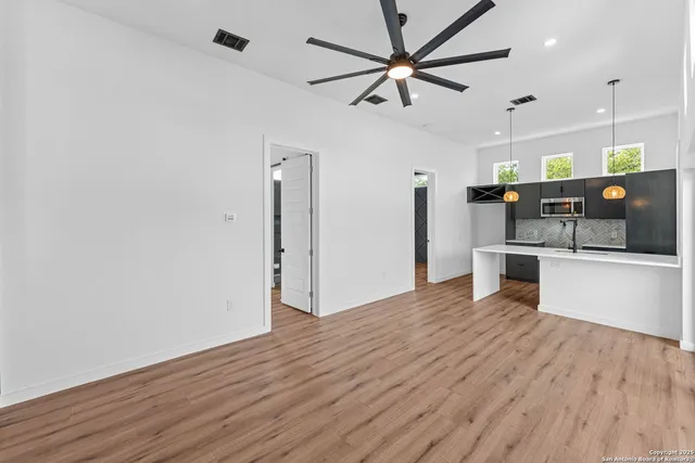 a view of a kitchen with a sink and stainless steel appliances