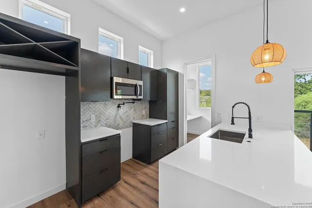 a kitchen with a sink and a refrigerator