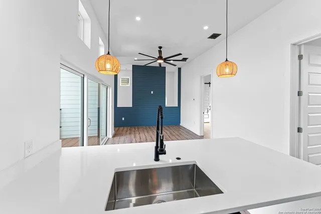 a kitchen with a sink a counter top space and stainless steel appliances