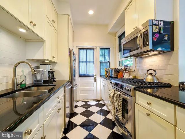 a kitchen with stainless steel appliances granite countertop a sink and a stove