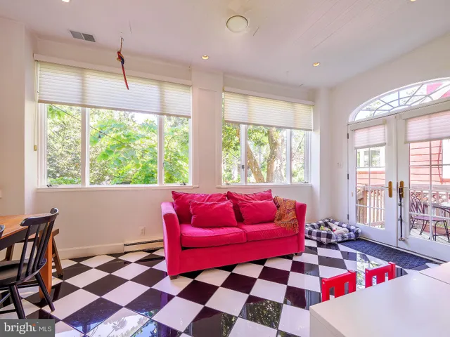 a living room with furniture and a floor to ceiling window