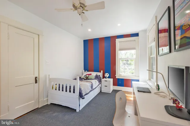 a bedroom with a bed table and window