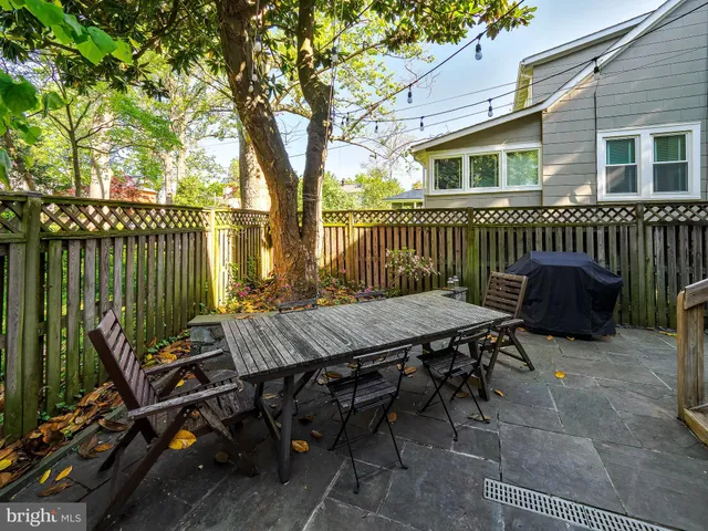 a view of backyard with deck and outdoor seating