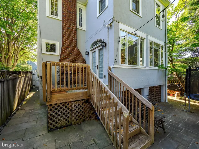 a front view of a house with a porch and garden