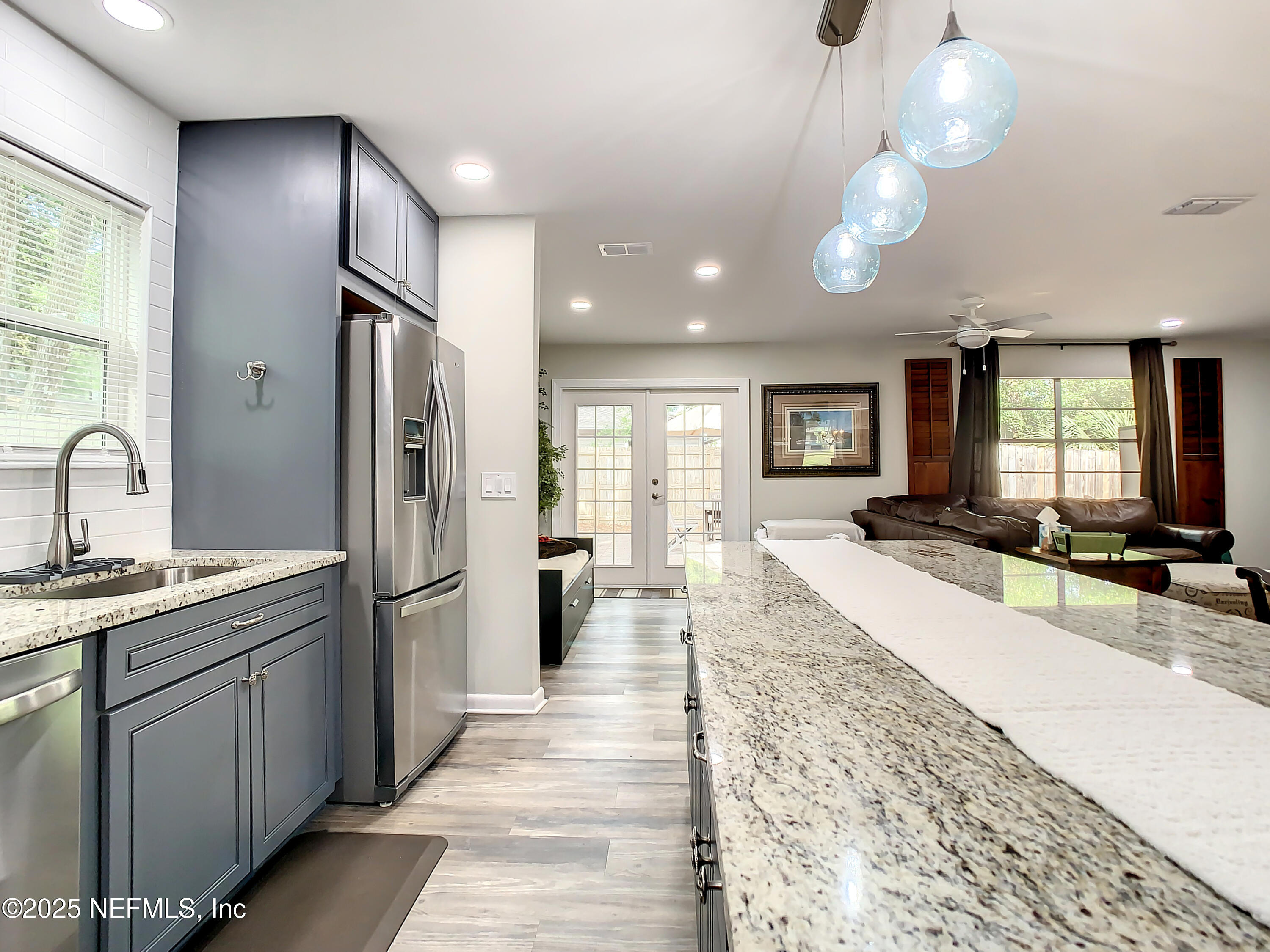 460 Lobelia Road St. Augustine, FL 32086 - Photo 11 of 34 a large kitchen with stainless steel appliances a large counter top a sink a refrigerator and window