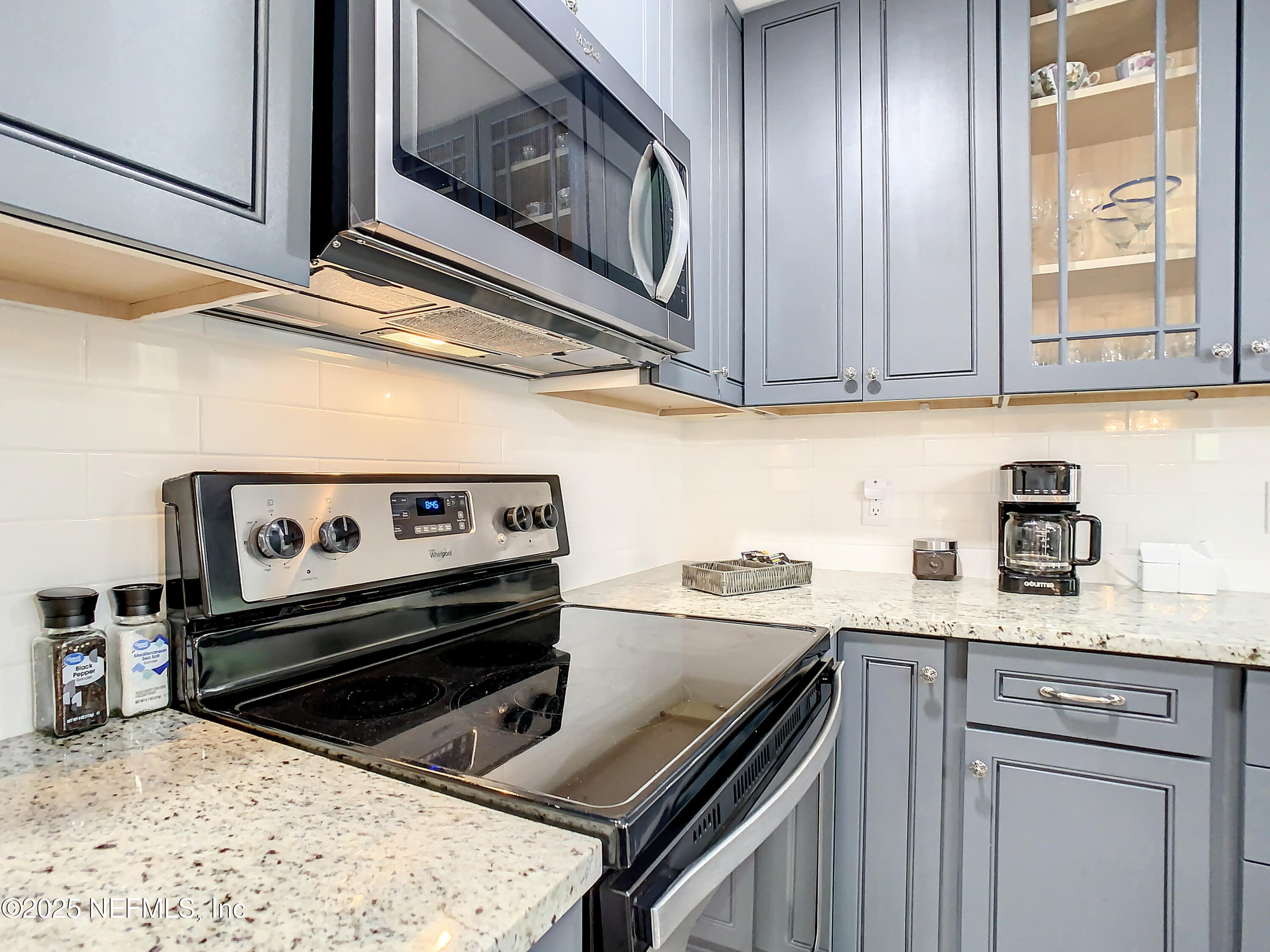 460 Lobelia Road St. Augustine, FL 32086 - Photo 12 of 34 a kitchen with a stove a sink and a microwave