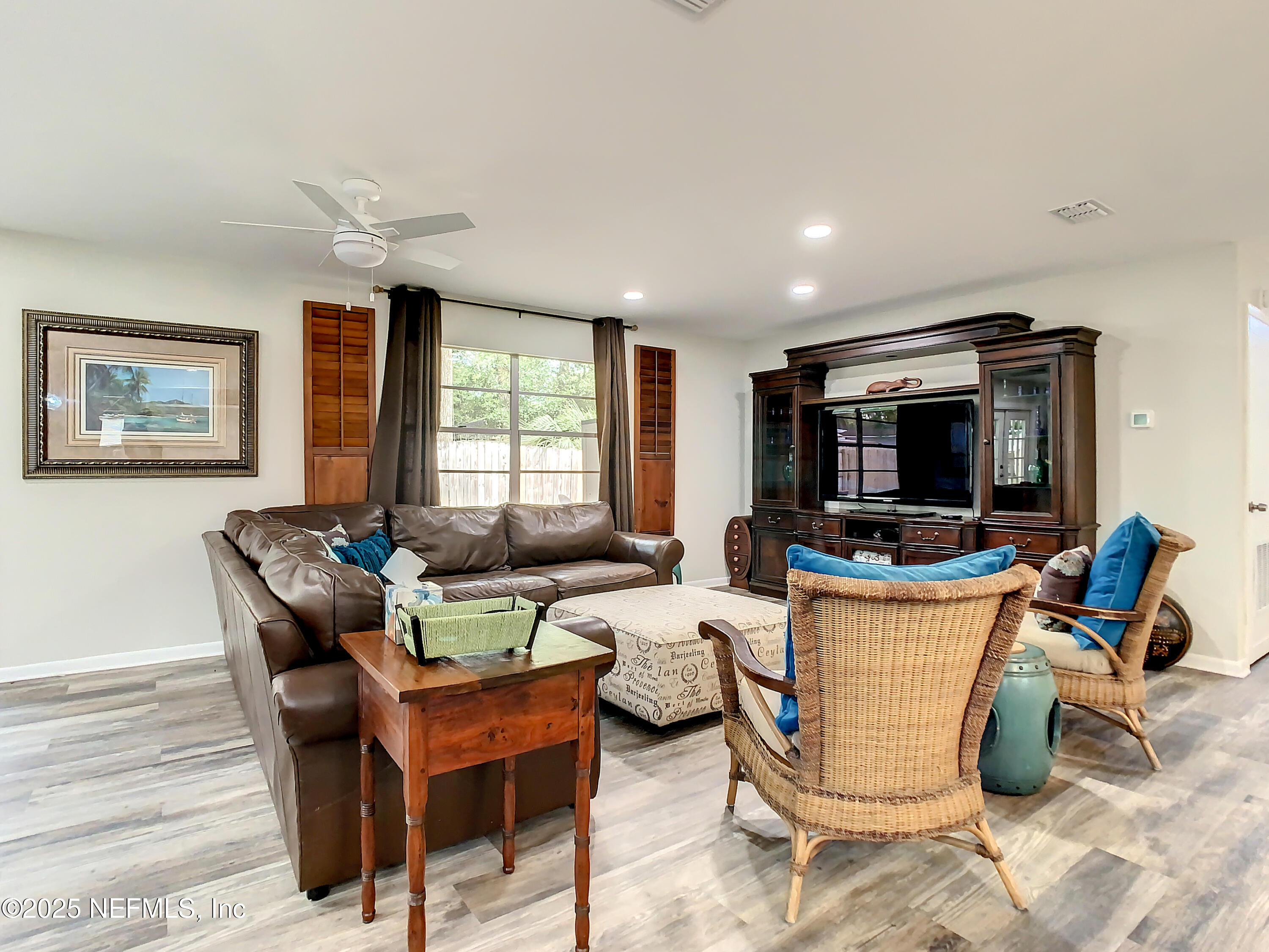 460 Lobelia Road St. Augustine, FL 32086 - Photo 15 of 34 a living room with furniture a flat screen tv and a large window