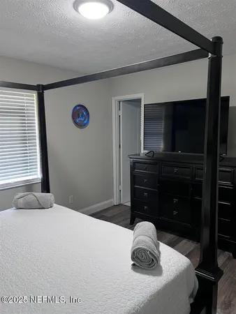 a bedroom with a bed and a television