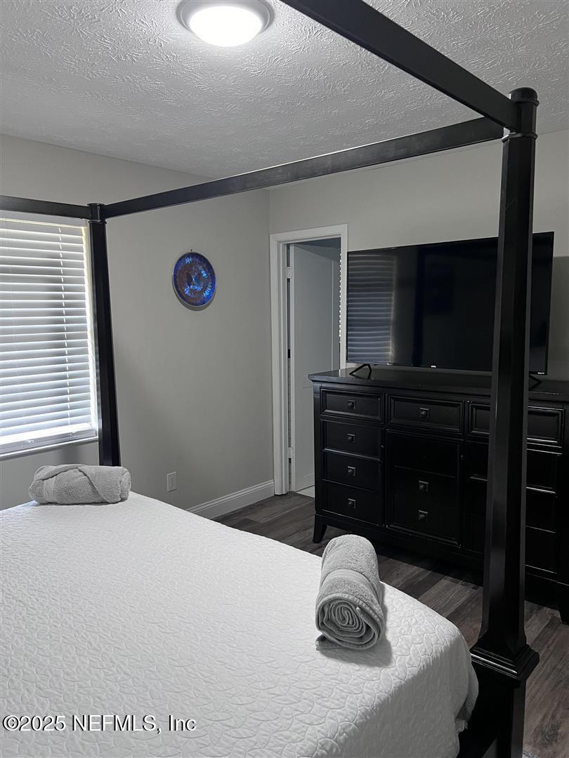 460 Lobelia Road St. Augustine, FL 32086 - Photo 20 of 34 a bedroom with a bed and a television