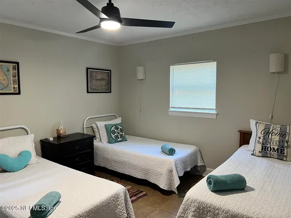 a bedroom with two beds and a couch