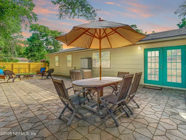 a backyard of a house with table and chairs