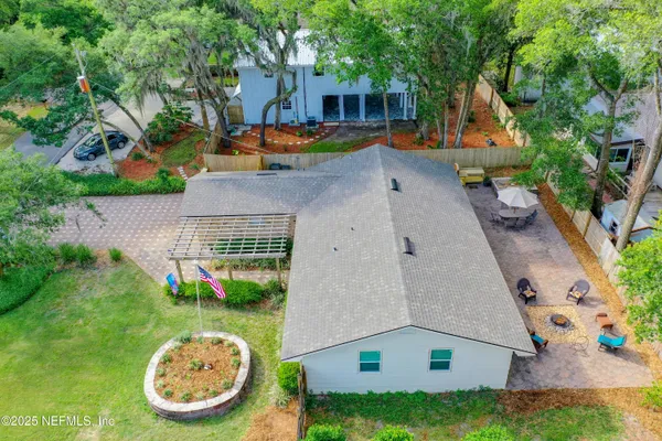 an aerial view of a house with garden space and swimming pool