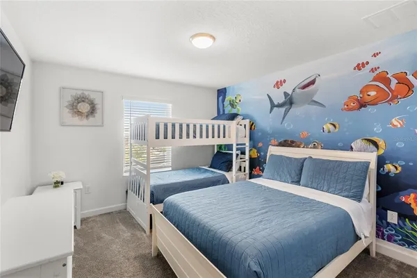 a bedroom with a bed and a chandelier