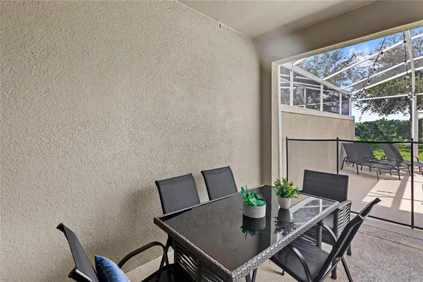 a view of a patio with a table and chairs