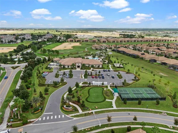 an aerial view of a swimming pool patio and lake view
