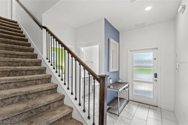 a view of entryway and hall with wooden floor