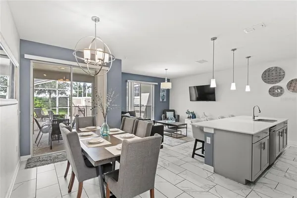 a view of a dining room with furniture wooden floor and chandelier